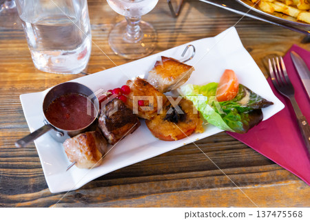 Duck breast on a skewer with currant sauce. French cuisine Duck breast on a skewer with currant sauce. French cuisine 137475568