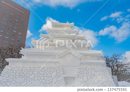 Large snow sculptures at the Sapporo Snow Festival towering under the blue sky (Sapporo, Hokkaido) 137475591