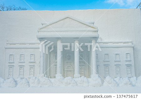 Large snow sculptures at the Sapporo Snow Festival towering under the blue sky (Sapporo, Hokkaido) 137475617