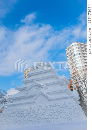 Large snow sculptures at the Sapporo Snow Festival towering under the blue sky (Sapporo, Hokkaido) 137475654