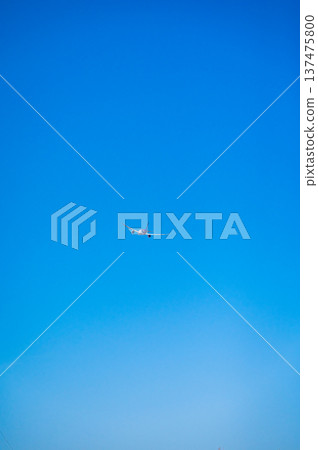 A view of New Chitose Airport with an airplane flying under a blue sky (Chitose City, Hokkaido) A view of New Chitose Airport with an airplane flying under a blue sky (Chitose City, Hokkaido) 137475800
