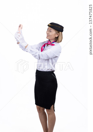 Air hostess gesturing to show safety instructions in studio Air hostess gesturing to show safety instructions in studio 137475825
