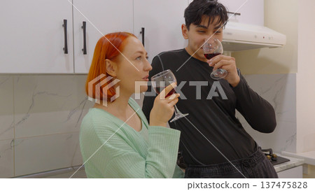 Couple sitting in the kitchen and drinking coffee Couple sitting in the kitchen and drinking coffee 137475828