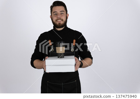 Professional waiter holding food delivery boxes in studio Professional waiter holding food delivery boxes in studio 137475940