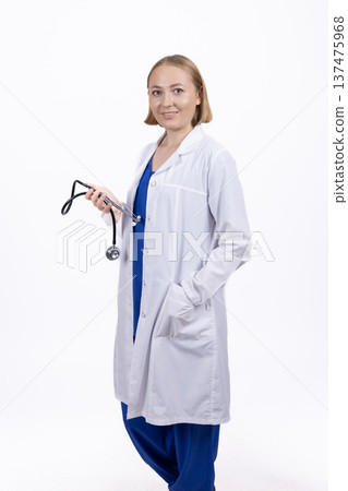 Female doctor standing with stethoscope in professional studio Female doctor standing with stethoscope in professional studio 137475968
