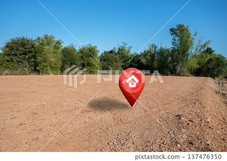 House symbol with location pin and Empty dry cracked swamp reclamation soil, land plot for housing construction project with and beautiful sunset sky with fresh air Land for sales landscape concept 137476350