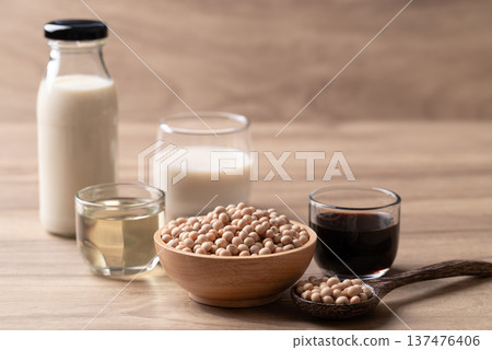 Assorted soy products: soy milk, soy sauce and soybean oil on wooden background Assorted soy products: soy milk, soy sauce and soybean oil on wooden background 137476406