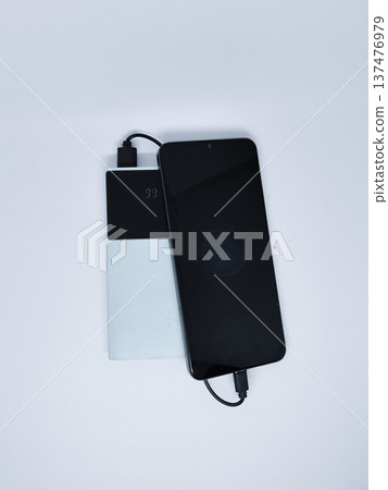 power bank is charging the cellphone power bank is charging the cellphone 137476979
