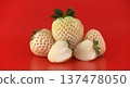 Unique white pineberries with red seeds on a vibrant red background 137478050