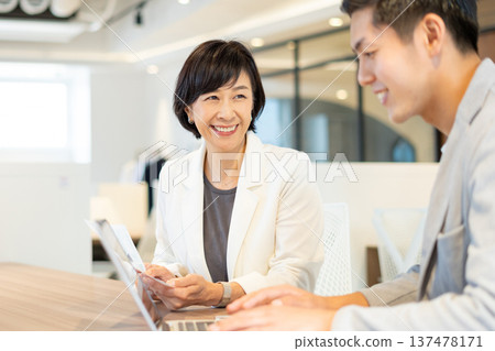 Men and women having a meeting in a coworking space 137478171