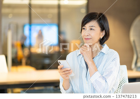 Senior woman operating a smartphone 137478213