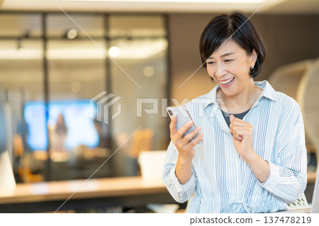 Senior woman operating a smartphone Senior woman operating a smartphone 137478219