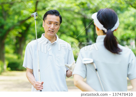 Senior couple with golf clubs Senior couple with golf clubs 137478410