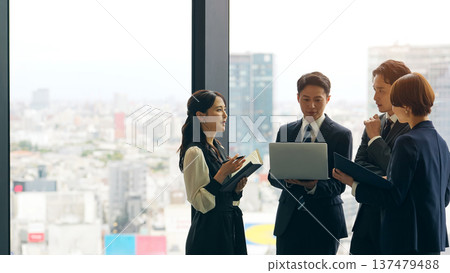 Group of business people having a conversation in the lobby Group of business people having a conversation in the lobby 137479488