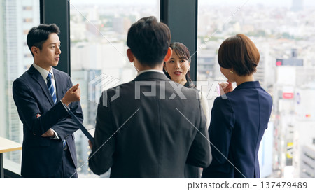 Group of business people having a conversation in the lobby Group of business people having a conversation in the lobby 137479489