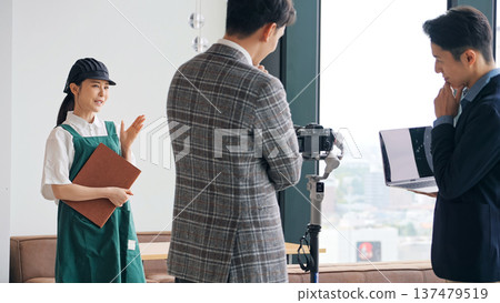 Restaurant staff and filming staff filming a promotional video inside the restaurant 137479519