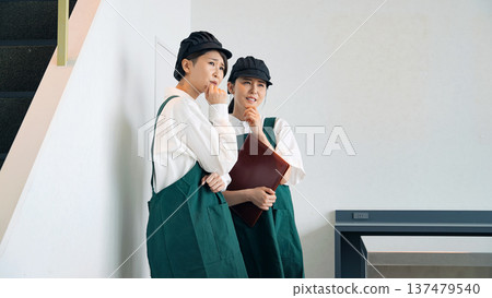 Restaurant staff whispering in the corner of the store 137479540