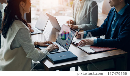 Group of casual business people meeting in an office Group of casual business people meeting in an office 137479566