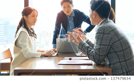 Group of casual business people meeting in an office Group of casual business people meeting in an office 137479634