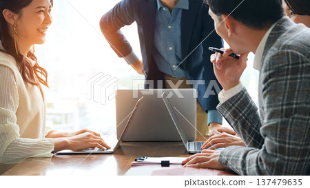 Group of casual business people meeting in an office Group of casual business people meeting in an office 137479635