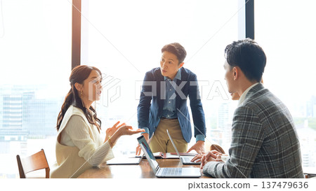 Group of casual business people meeting in an office Group of casual business people meeting in an office 137479636
