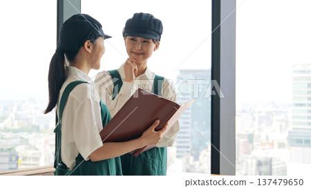 A restaurant employee looking at a file inside the store 137479650
