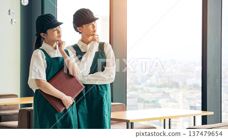 A restaurant employee thinking inside the store A restaurant employee thinking inside the store 137479654
