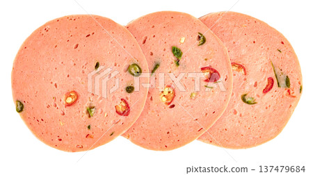 Three slices of spicy bologna sausage with pieces of red and green chili pepper embedded.Top view of gourmet deli meat for sandwiches and snack platters. Three slices of spicy bologna sausage with pieces of red and green chili pepper embedded.Top view of gourmet deli meat for sandwiches and snack platters. 137479684