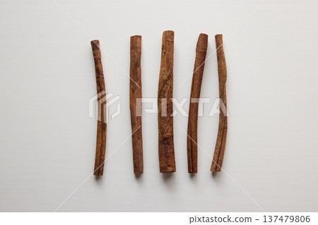 Cinnamon sticks arranged as spice ingredients on a white background Cinnamon sticks arranged as spice ingredients on a white background 137479806