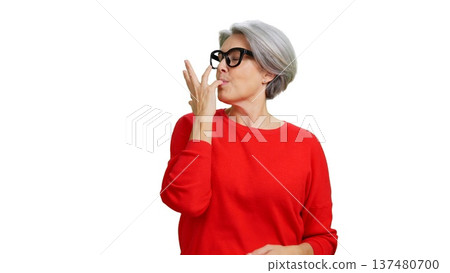 Mature woman licking fingers enjoying delicious taste 137480700