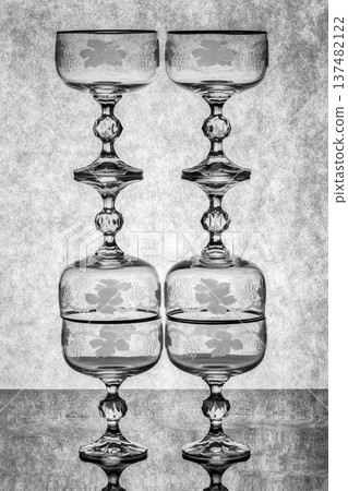Still life with glassware on a reflective surface 137482122