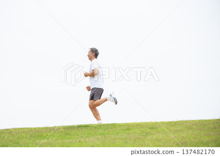 Man running along the bank Man running along the bank 137482170