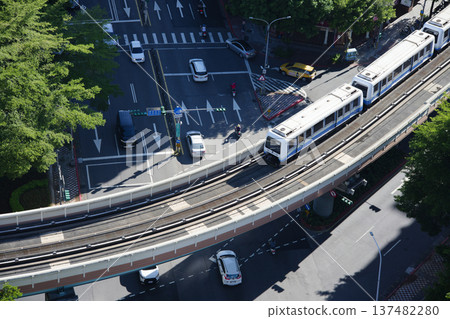 Looking down at Taipei Metro trains passing through busy city intersections Looking down at Taipei Metro trains passing through busy city intersections 137482280