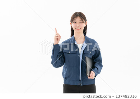 A young female engineer in work clothes on a white background A young female engineer in work clothes on a white background 137482316