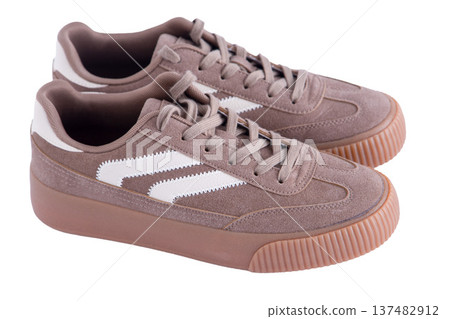 Sneakers isolated on black background top view. Suede light brown beige Sneakers isolated on black background top view. Suede light brown beige 137482912