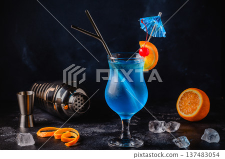 Glass of blue lagoon cocktail decorated with orange and cherry Glass of blue lagoon cocktail decorated with orange and cherry 137483054