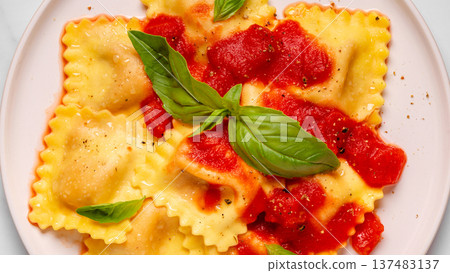 Delicious appetizing ravioli with tomato sauce and basil 137483137