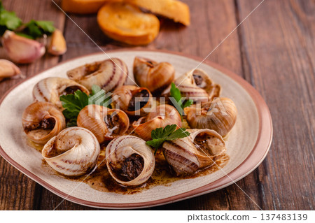 snails with butter on a plate snails with butter on a plate 137483139