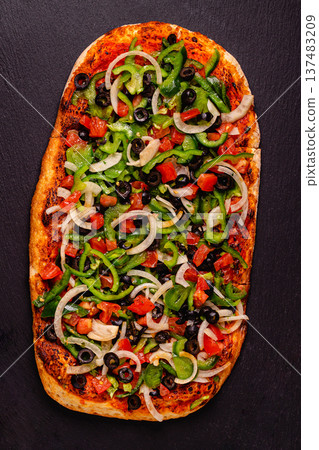 Homemade vegan pizza with tomatoes, peppers, olives, onions and herbs. Homemade vegan pizza with tomatoes, peppers, olives, onions and herbs. 137483209
