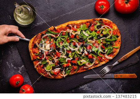 Homemade vegan pizza with tomatoes, peppers, olives, onions and herbs. Homemade vegan pizza with tomatoes, peppers, olives, onions and herbs. 137483215