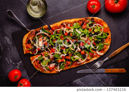 Homemade vegan pizza with tomatoes, peppers, olives, onions and herbs. Homemade vegan pizza with tomatoes, peppers, olives, onions and herbs. 137483216