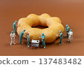 Miniature Surgeons Performing Operation on Donut Concept 137483482