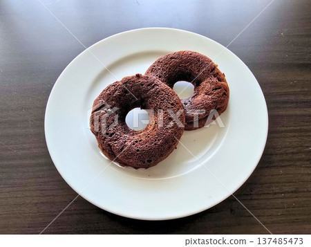 Chocolate donut on a white plate 137485473