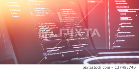 Futuristic Software Coding Workspace with Warm Gradient Light Overlay and Source Code on Screens Futuristic Software Coding Workspace with Warm Gradient Light Overlay and Source Code on Screens 137485740