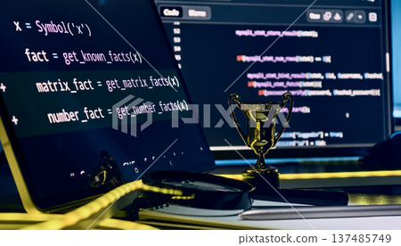 Award-Winning Software Development Concept with Gold Trophy, Source Code Screens and Futuristic Coding Workspace 137485749