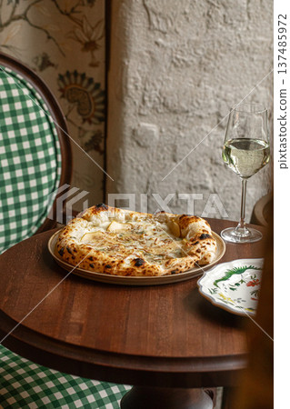 Four cheese pizza with white wine 137485972