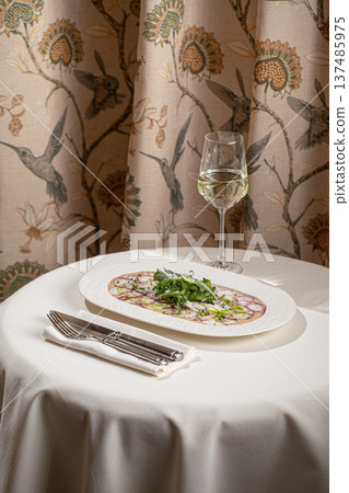 Octopus carpaccio with arugula and parmesan Octopus carpaccio with arugula and parmesan 137485975