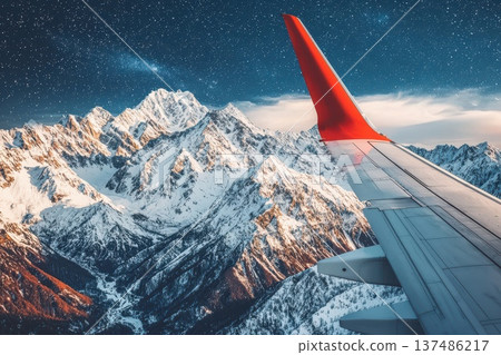 Captivating Night Flight Over Majestic Mountains Under Starry Sky with Plane Wing 137486217