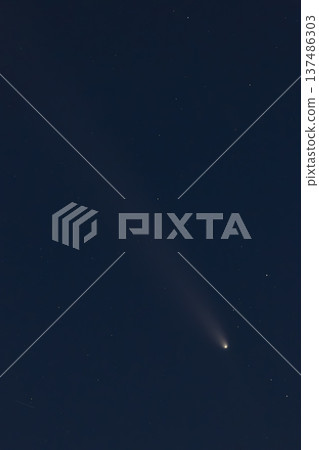 Comet with glowing tail moving through dark space 137486303