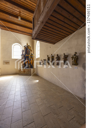 Church interior with ancient wooden statues and altar in Pribylina 137486511